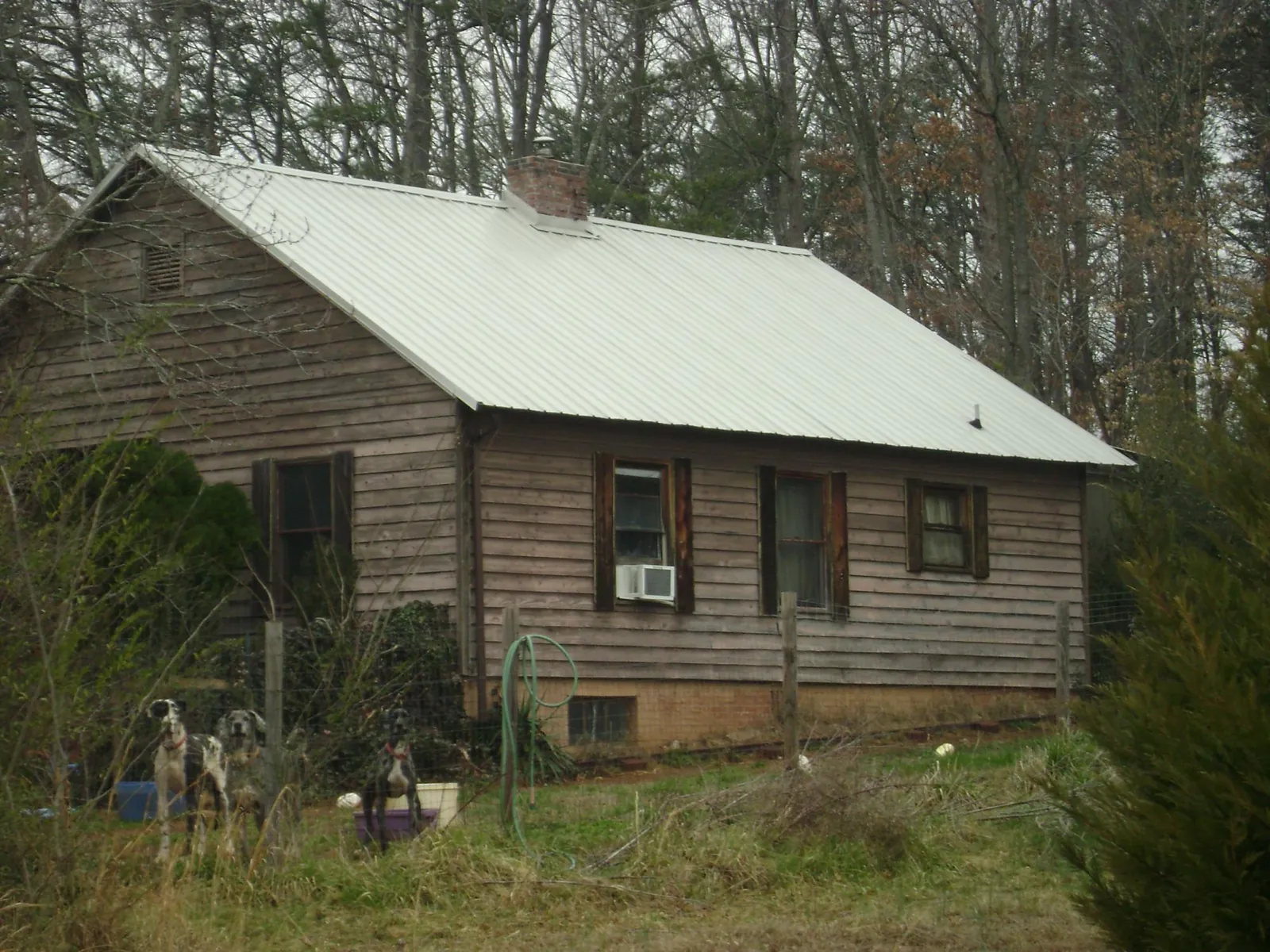White metal roof on an old wood sided farmhouse, from a Metal Roof Installation job in Ernul